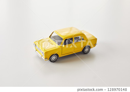 Yellow Toy Car on Clean White Background Yellow Toy Car on Clean White Background 128970148