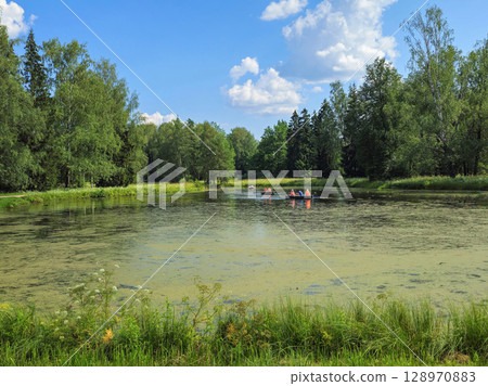 Boats float on an ancient pond. 128970883