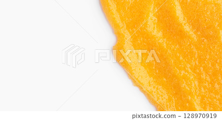 The texture of a orange body scrub with particles. Close-up 128970919