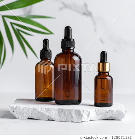 Amber Glass Cosmetic Bottles on Stone Slab with Green Leaf Minimalist Style Amber Glass Cosmetic Bottles on Stone Slab with Green Leaf Minimalist Style 128971181