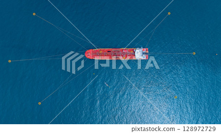 Aerial view oil tanker ship vessel loading and unloading in oil terminal station refinery, Global business import export logistic transport sea freight cargo tanker ship crude oil tanker ship at port. 128972729