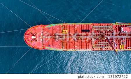 Aerial view oil tanker ship vessel loading and unloading in oil terminal station refinery, Global business import export logistic transport sea freight cargo tanker ship crude oil tanker ship at port. 128972732