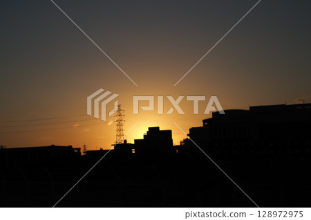 A city stained by the setting sun A city stained by the setting sun 128972975