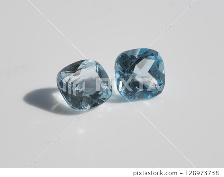 Stunning Natural Blue Topaz Gemstones Pair, Radiant Cushion Cut, Sparkling Crystal Clear, Light Azure Color, Jewelry Making, Isolated Studio Shot. 128973738