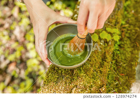 Brewing matcha in a mossy 128974274