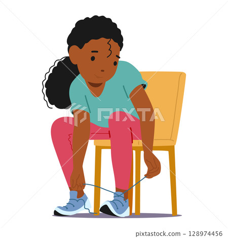 Concentrated little preschool girl kid cartoon character learning to tie shoelaces sitting on chair 128974456