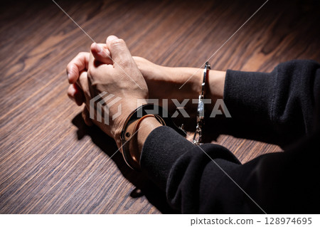 Criminal handcuffs interrogation 128974695
