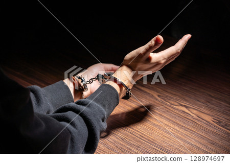 Criminal handcuffs interrogation Criminal handcuffs interrogation 128974697