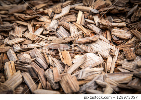 Close-Up of Natural Wooden Mulch Texture for Landscaping, Gardening, or Biofuel Concepts Close-Up of Natural Wooden Mulch Texture for Landscaping, Gardening, or Biofuel Concepts 128975057