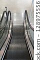 Empty escalator going down in a modern shopping mall 128975556