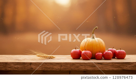 Rustic autumn harvest display with pumpkin, apples, and wheat on wood. Thanksgiving and natural bounty. 128976473