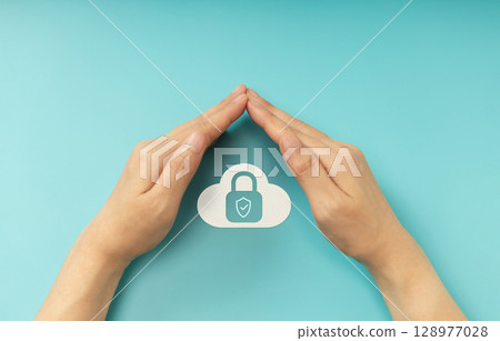 Hands shielding Padlock on Cloud symbol, Cybersecurity, data privacy and online protection. Top View Hands shielding Padlock on Cloud symbol, Cybersecurity, data privacy and online protection. Top View 128977028