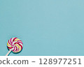 Swirl Lollipop on Blue, Sweet Treat and Childhood Fun 128977251