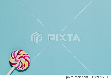 Swirl Lollipop on Blue, Sweet Treat and Childhood Fun Swirl Lollipop on Blue, Sweet Treat and Childhood Fun 128977251