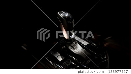 EV Car gear. Close up of modern automatic car gear shifters in luxury vehicle interiors. Feature sleek ergonomic designs and advanced car transmission controls for premium driving experience. EV gear 128977327