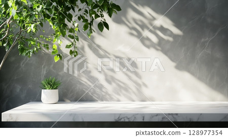 Table top marble counter grey cement wall with shadow sunlight from plant 128977354