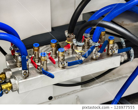 Complex arrangement of piping and valves in industrial machinery for efficient fluid control Complex arrangement of piping and valves in industrial machinery for efficient fluid control 128977555