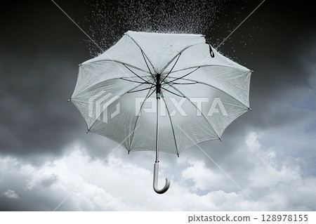 Umbrella suspended in the sky with rain falling, surrounded by vibrant clouds and a dramatic atmosphere 128978155
