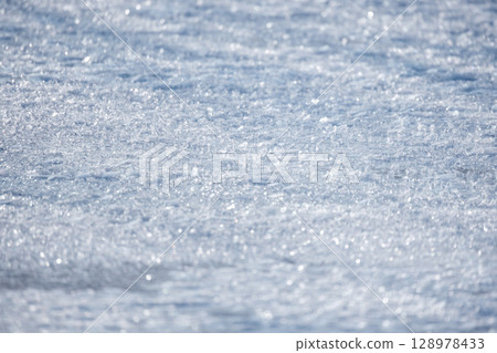 Close-Up of Glittering Ice Crystals on a Wintery Frozen Surface 128978433