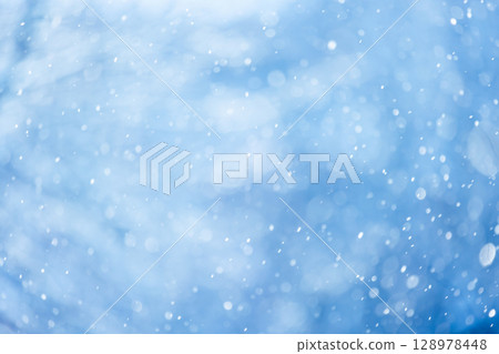 Abstract Background of Snowflakes in the Winterly Blue Atmosphere 128978448