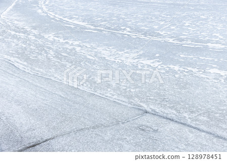 Natural Winter Scene Featuring a Frozen Surface and Smooth Ice Textures Natural Winter Scene Featuring a Frozen Surface and Smooth Ice Textures 128978451