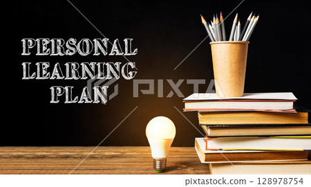 A stack of books with a light bulb on top of them 128978754