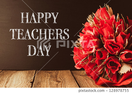 a wooden table with the words Happy Teachers Day 128978755