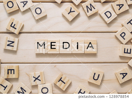Wooden board with a large jumble of letters scattered across it Wooden board with a large jumble of letters scattered across it 128978854