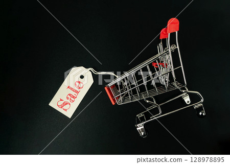 Shopping cart with a sale tag on it Shopping cart with a sale tag on it 128978895