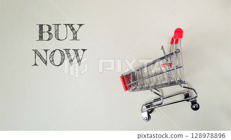 Shopping cart with the words buy now written on it Shopping cart with the words buy now written on it 128978896