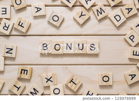 Bunch of wooden letters spell out the word bonus Bunch of wooden letters spell out the word bonus 128978899