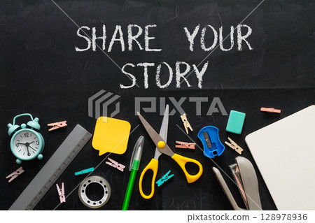 A blackboard with the words share your story written on it 128978936