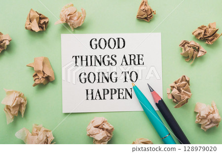 Piece of paper with the words "Good things are going to happen" written on it Piece of paper with the words "Good things are going to happen" written on it 128979020