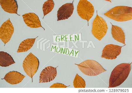 A collection of autumn leaves with the word "Green Monday" written in green on t 128979025