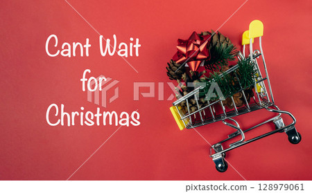 Shopping cart with a Christmas tree on top of it 128979061