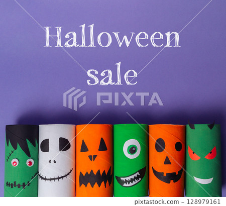 Bunch of Halloween themed paper tubes with faces on them Bunch of Halloween themed paper tubes with faces on them 128979161