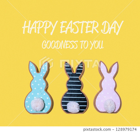Three Easter bunnies with a yellow background Three Easter bunnies with a yellow background 128979174