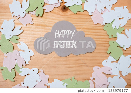 Wooden frame with a cloud and a bunch of Easter rabbits Wooden frame with a cloud and a bunch of Easter rabbits 128979177