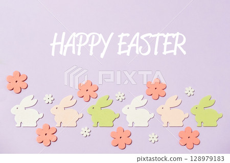 Colorful Easter bunny decoration with a purple background 128979183