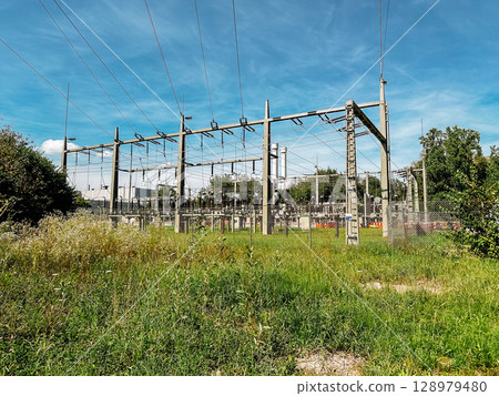 Power station with a lot of wires and poles Power station with a lot of wires and poles 128979480