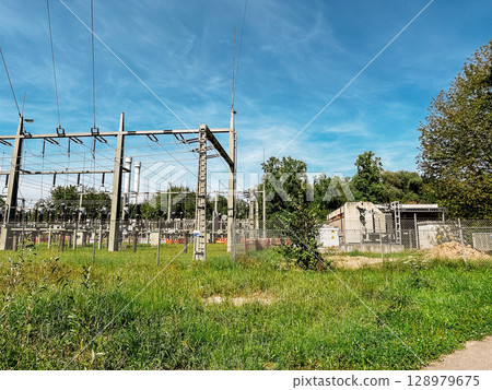 Large power station with a fence around it Large power station with a fence around it 128979675