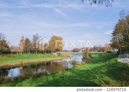 River runs through a park with a bridge over it River runs through a park with a bridge over it 128979719