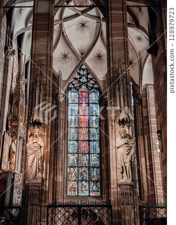 The stained glass window in the church is very colorful and has a lot of detail The stained glass window in the church is very colorful and has a lot of detail 128979723