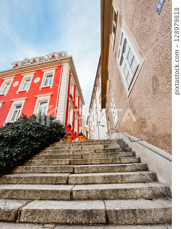 A red building with a white roof and a white sign on the side A red building with a white roof and a white sign on the side 128979818