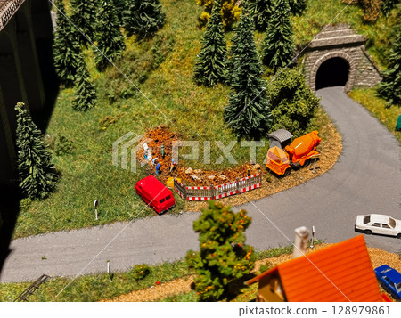 A model train scene with a red car that has crashed into a pile of orange cones A model train scene with a red car that has crashed into a pile of orange cones 128979861