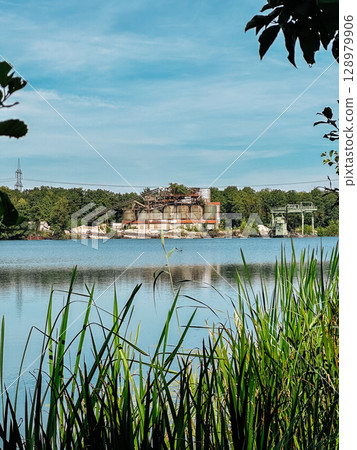 Lake with a building in the background Lake with a building in the background 128979906