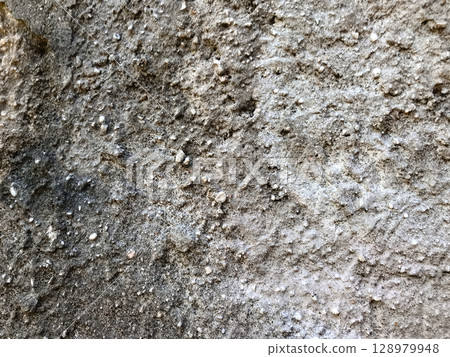 A wall with a lot of dirt and rocks on it A wall with a lot of dirt and rocks on it 128979948