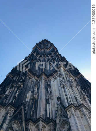 Cathedral in Cologne. The building is tall and has a lot of detail on it Cathedral in Cologne. The building is tall and has a lot of detail on it 128980016