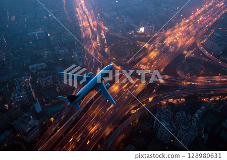 Airplane Flying Over a Busy Urban Highway Network During Twilight. 128980631
