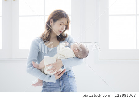 媽媽抱著一個嬰兒 媽媽抱著一個嬰兒 128981368